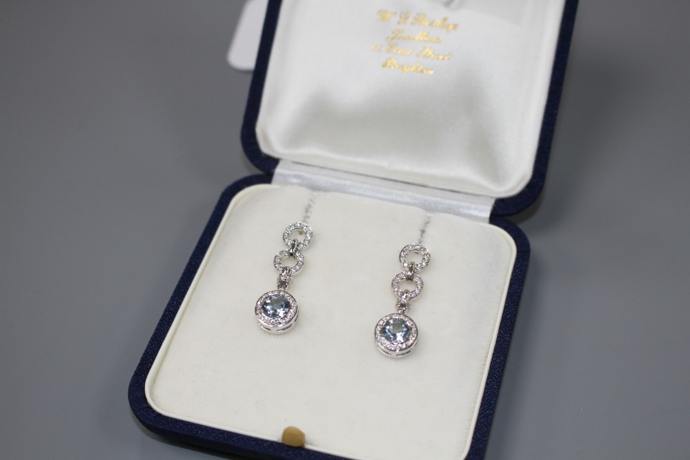 A modern pair of 18ct white gold, aquamarine and diamond set drop earrings, drop 29mm, gross weight 7.5 grams.